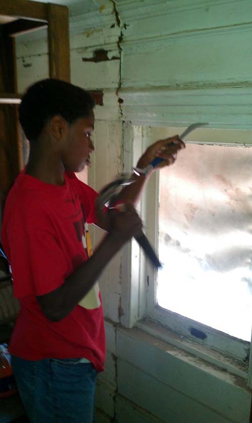 Jelani working on the window frames